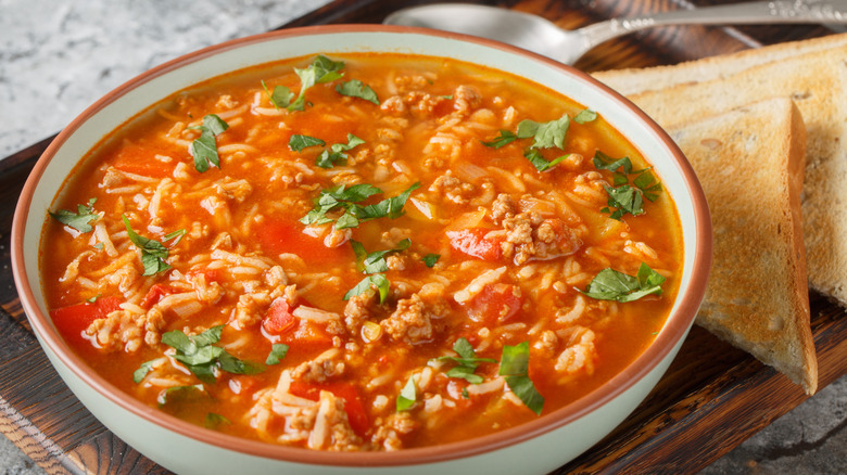 A bowl of stuffed bell pepper soup served with toasted bread