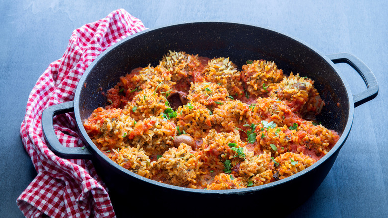 A cast iron pot of porcupine meatballs in tomato sauce