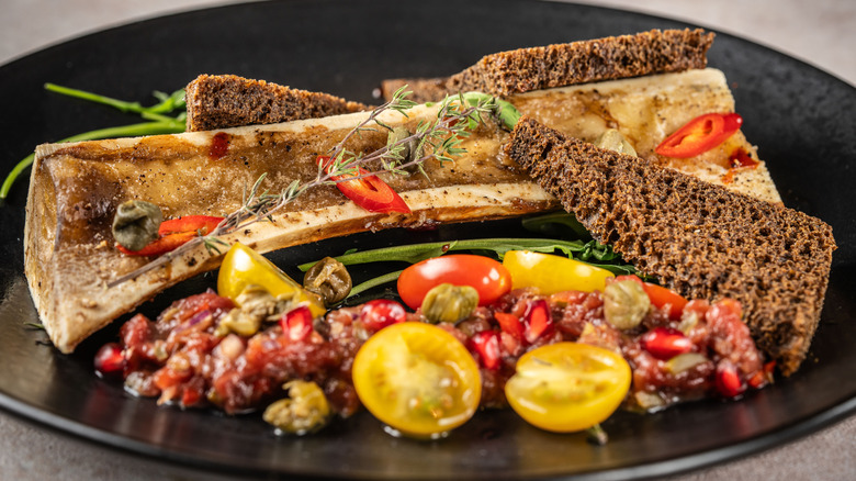 Roasted bone marrow served with rye toast and vegetables
