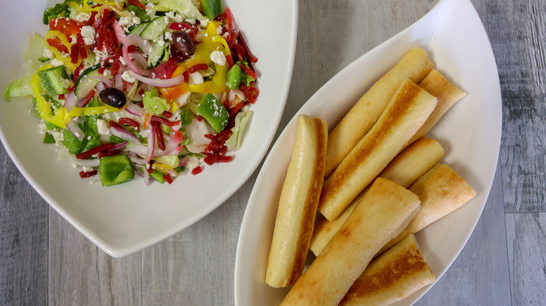 Salad and breadsticks.