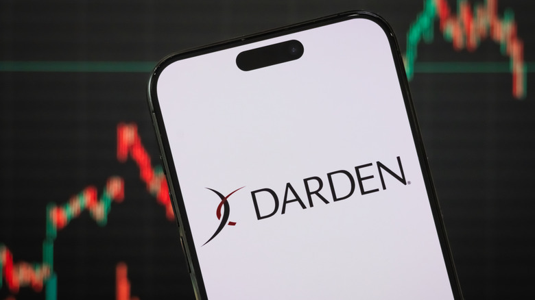 Darden Logo on a smart phone in front of statistics line