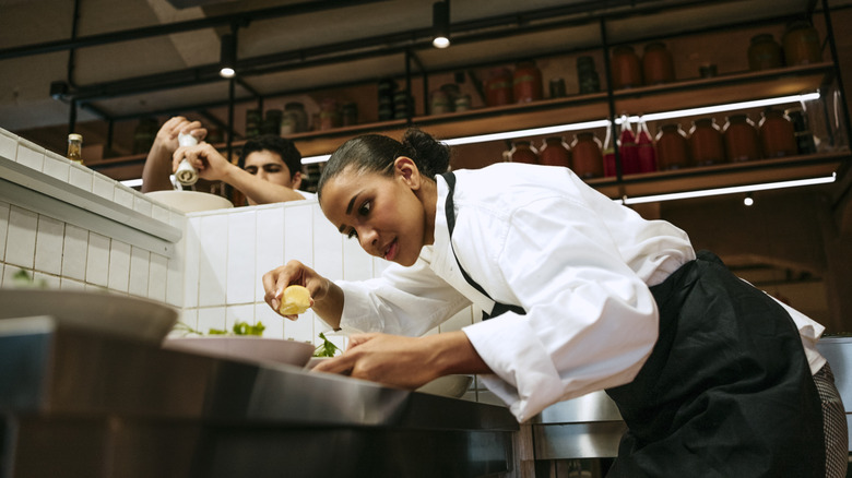 chefs cooking in professional kitchen