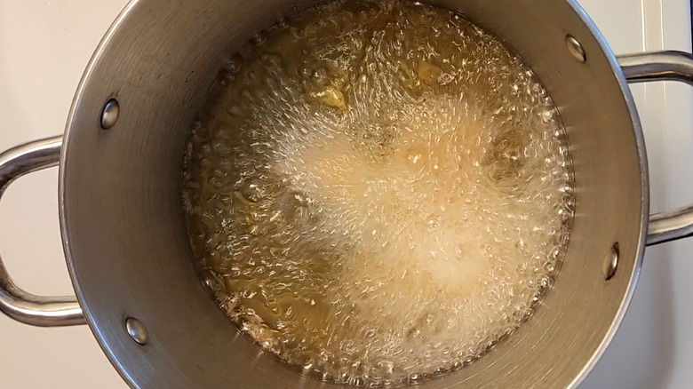 oil bubbling rapidly in pot