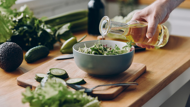 oil poured onto salad