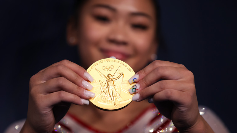 Sunisa Lee holding her gold medal