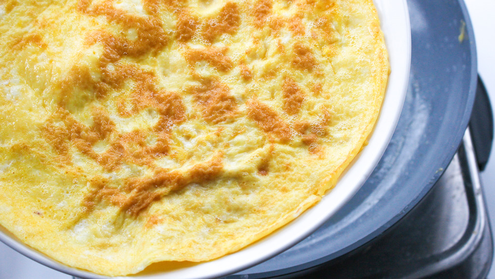 cooking an omelet with a frying pan