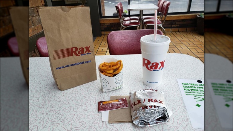 roast beef sandwich fries and drinks on table at Rax Roast Beef restaurant