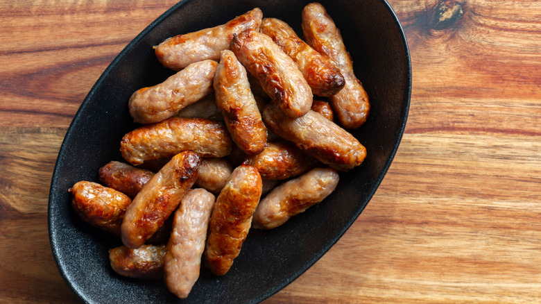 Little sausages on serving platter