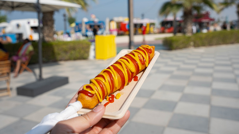 Corn dog with mustard and ketchup