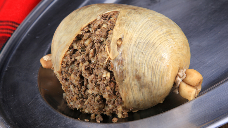 Traditional haggis sliced open on silver tray