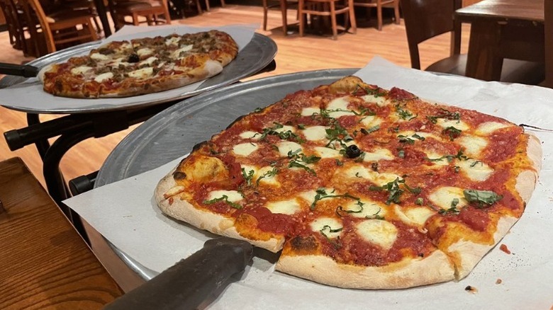Two Bertucci's pizzas on trays