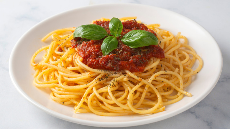 plate is seasoned spaghetti with sauce