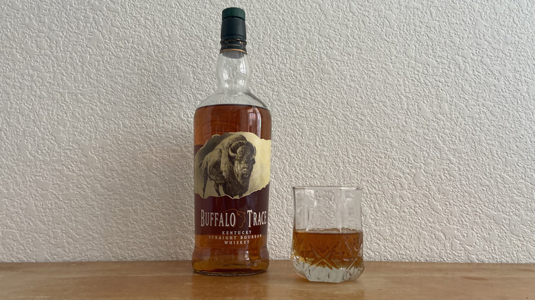 Bottle of Buffalo Trace bourbon with glass.