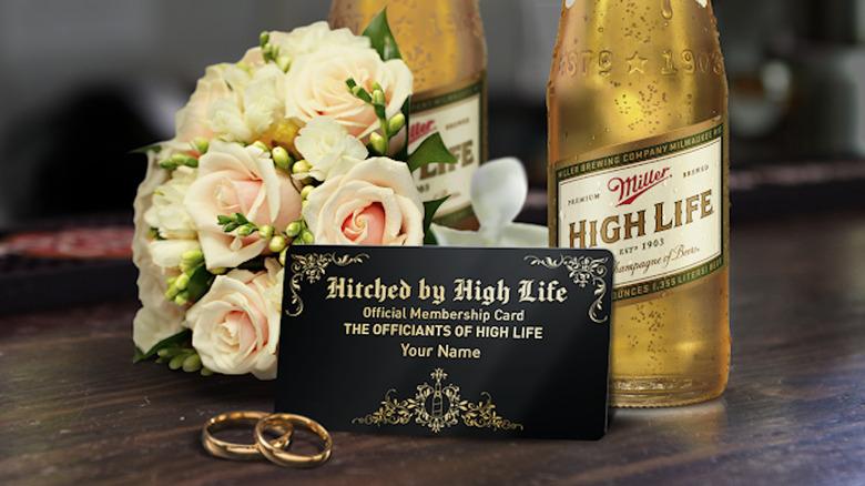 Miller high Life 'Official Membership Card' alongside beer bottles, flowers, and gold rings