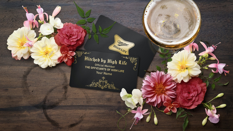 Miller High Life 'Official Member of the Officiants of High Life' card next to flowers and beer glass