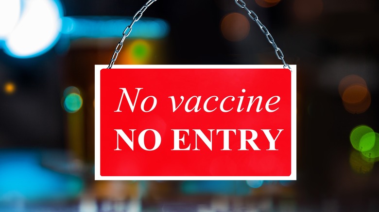 red sign declaring vaccine requirement