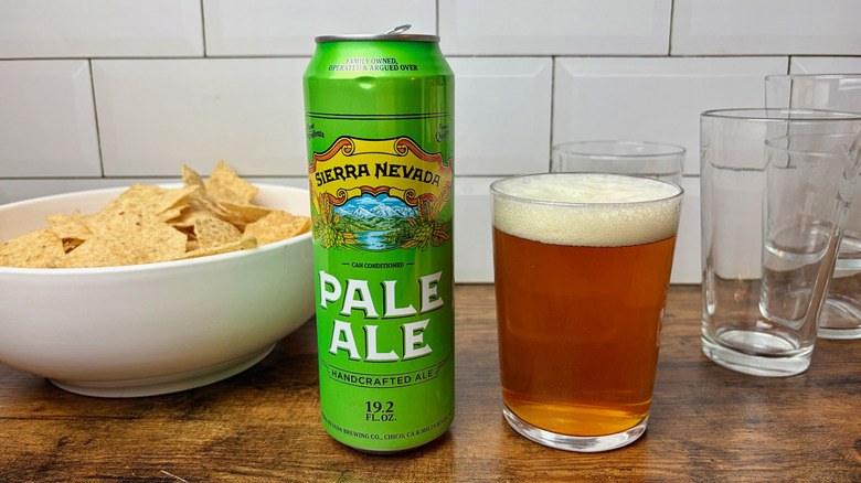 Tallboy can of Sierra Nevada pale ale on counter next to glass of beer