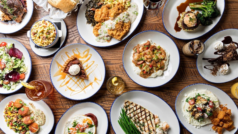 Various meals on plates on a wooden table