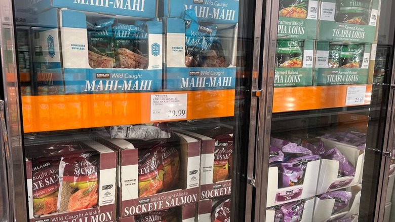 Inside Costco's freezer aisle with different types of frozen fish in case.