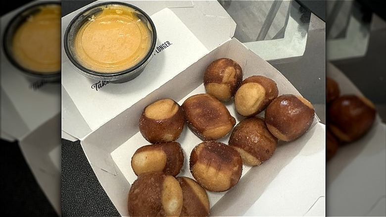 Culver's pretzel bites in a box with a container of Wisconsin cheddar cheese sauce