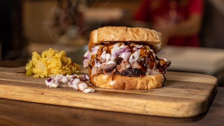 Barbecue sandwich with a side of rice on cutting board