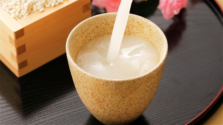 Pouring Japanese rice drink Amazake