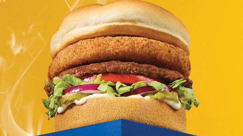 A promotional photo of th Cheddar ﻿CurderBurger on a yellow background