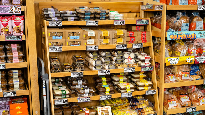 A baked goods display at Trader Joe's filled with cakes, cookies, and breads.