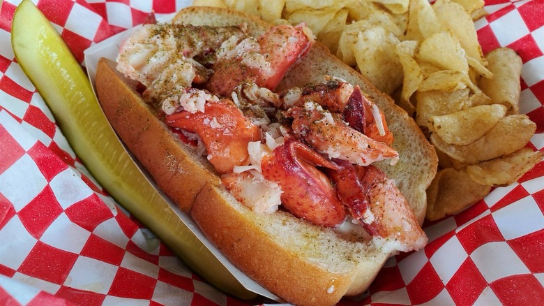 Lobster roll from Luke's Lobster with pickle spear and potato chips