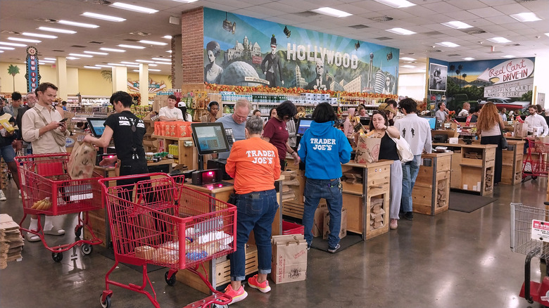 Cashiers check out customers at Trader Joe's registers in Hollywood, CA