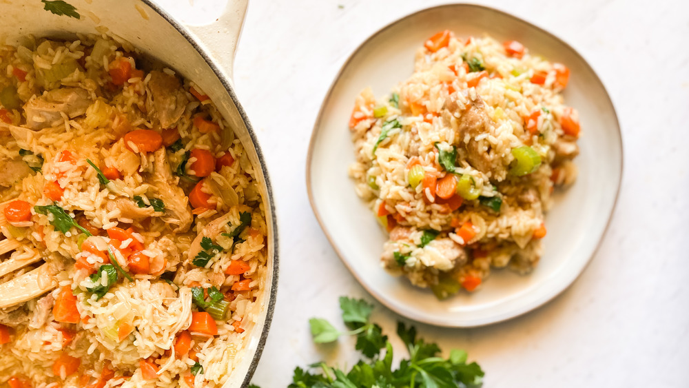 pot of chicken and rice next to plated chicken and rice