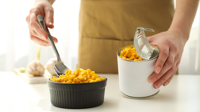 Person cooking canned corn