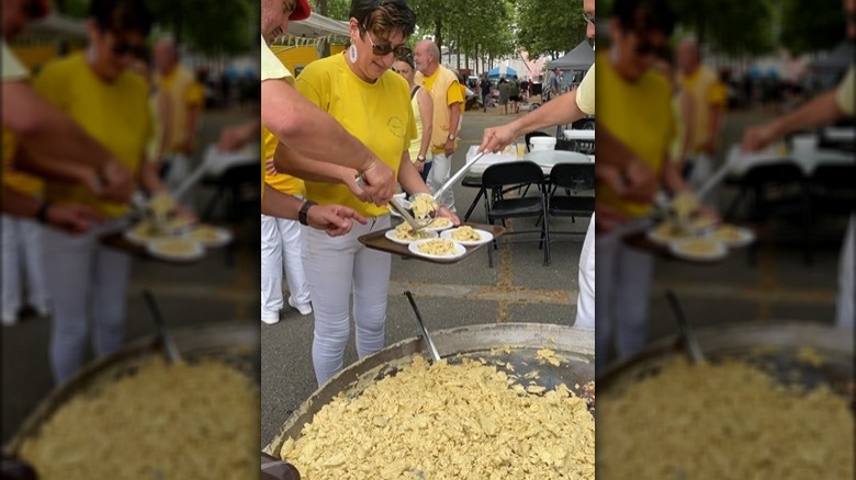Chefs serving giant omelet in Bessières, France