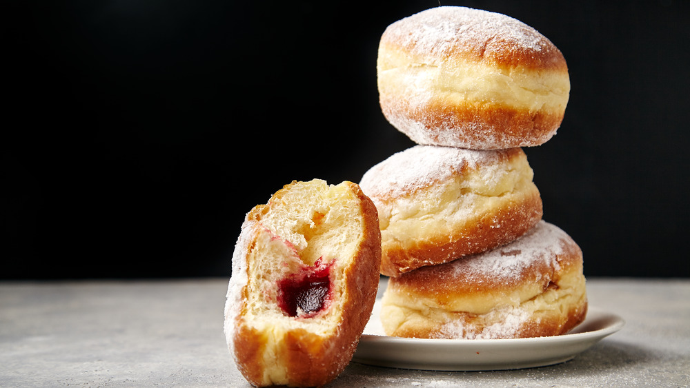 Jelly donuts precariously stacked