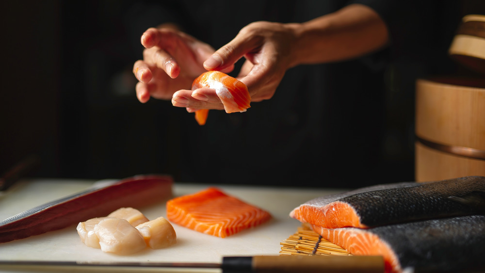 A close-up photo of a chef preparing sushi