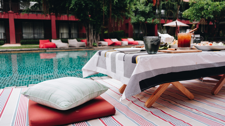 picnic spread next to a pool