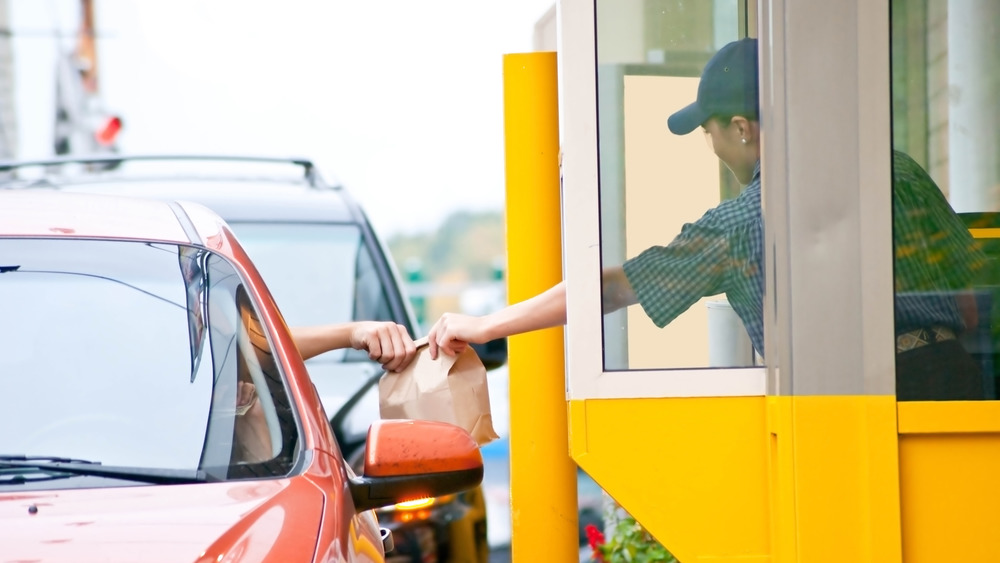 Drive-thru worker handing over food