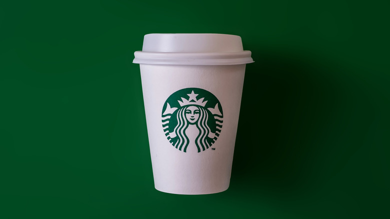 Starbucks hot drink cup on green background