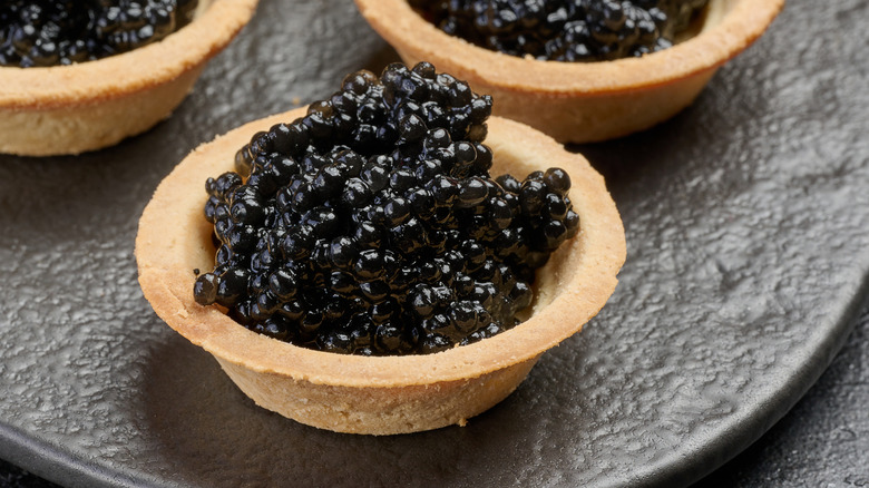 A plate of bowls full of beluga caviar.