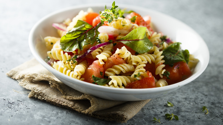 pasta salad with tomatoes and greens