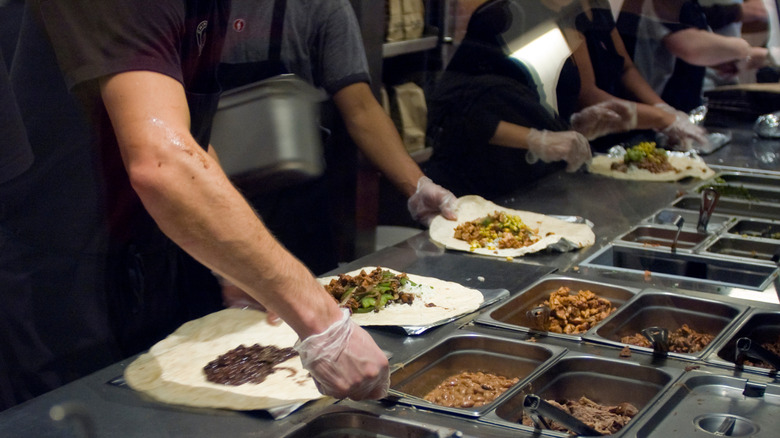 Chipotle employees making burritos.