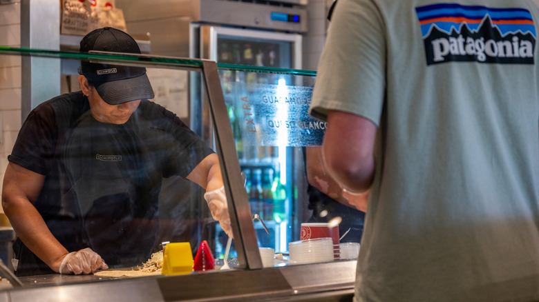 Chipotle employee making customer order