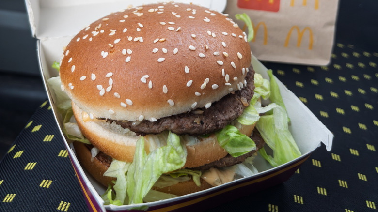 Big Mac in box on car passenger seat.