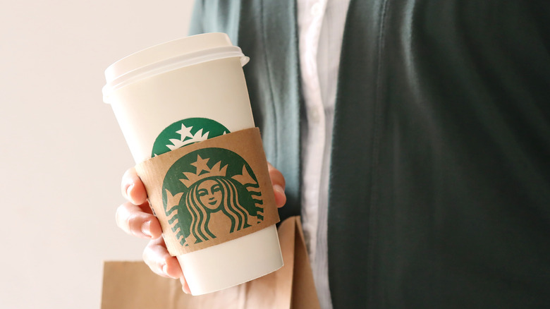 Man picking up Starbucks order