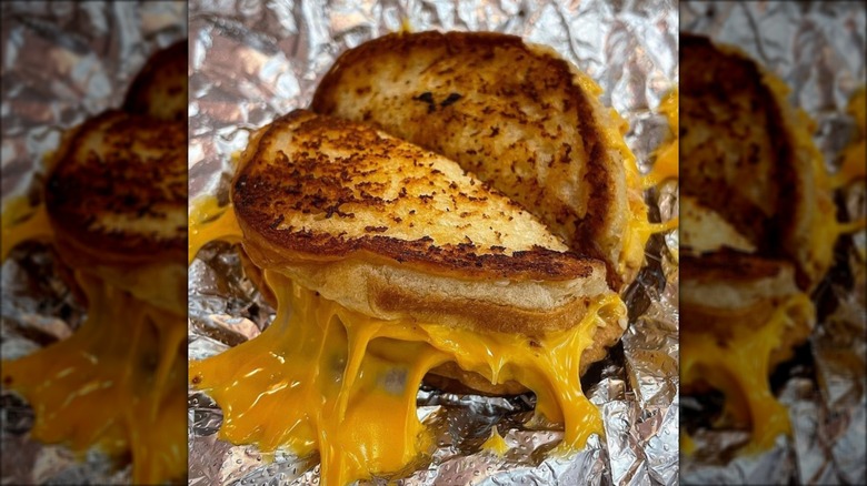 Grilled cheese sandwich from Five Guys on aluminum wrap.