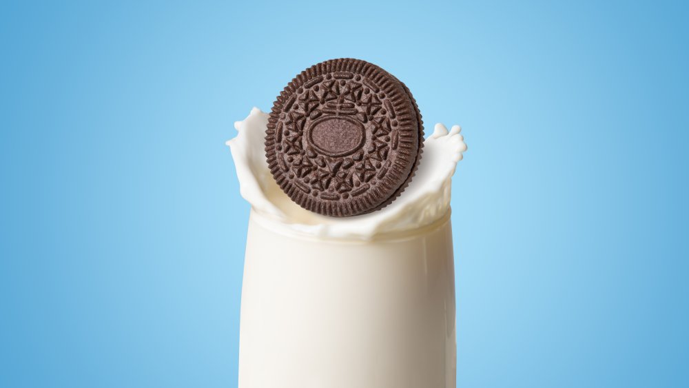 Oreo falling into a glass of milk