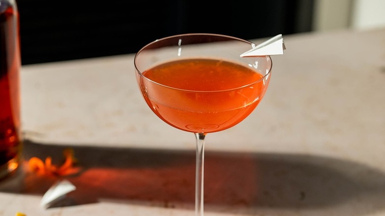 cocktail with paper plane garnish
