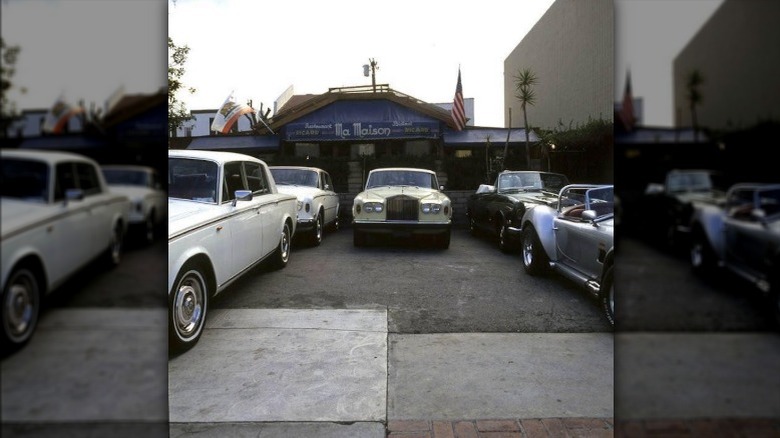 Luxury cars parked outside of Ma Maison