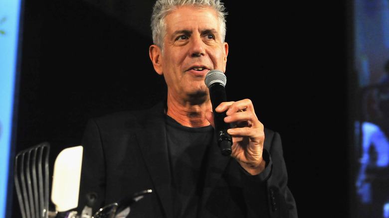 Anthony Bourdain speaking into microphone