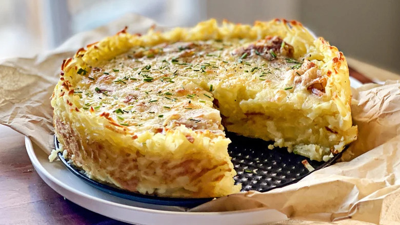 Spanish Tortilla-Inspired Quiche With Hash Brown Crust with slice missing